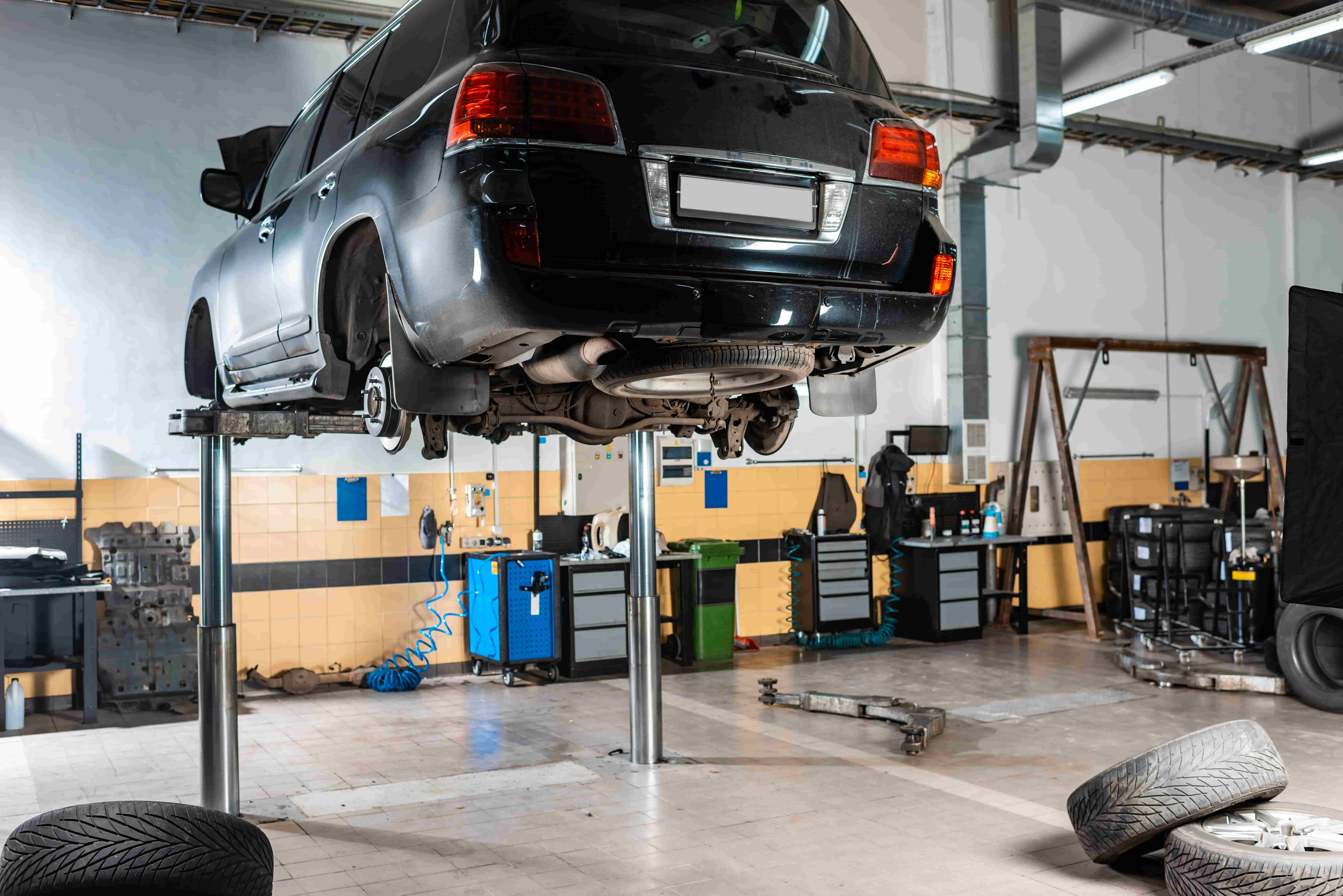 Car Servicing & Repairs in Campbellfield Professional vehicle inspection in Campbellfield - Blue sedan on hydraulic lift for complete undercarriage service and repairs